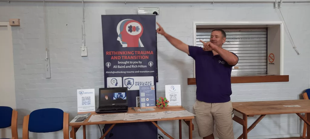 We called the podcast Rethinking Trauma and Transition and we were running our own companies at the time (Ali still is). Banner on display at an Army Welfare Service event. Rich is posing