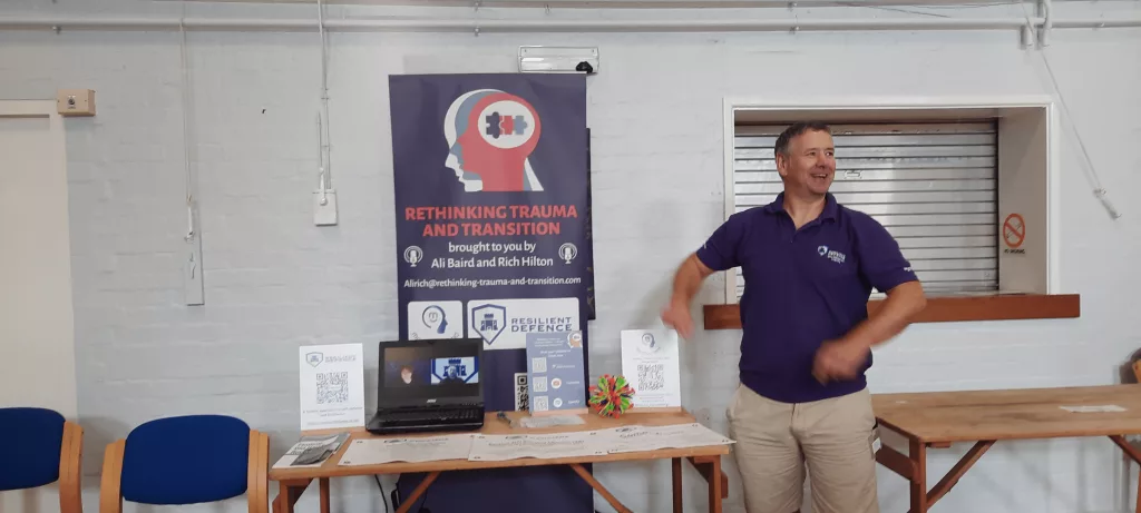 We called the podcast Rethinking Trauma and Transition and we were running our own companies at the time (Ali still is). Banner on display at an Army Welfare Service event. Rich is posing