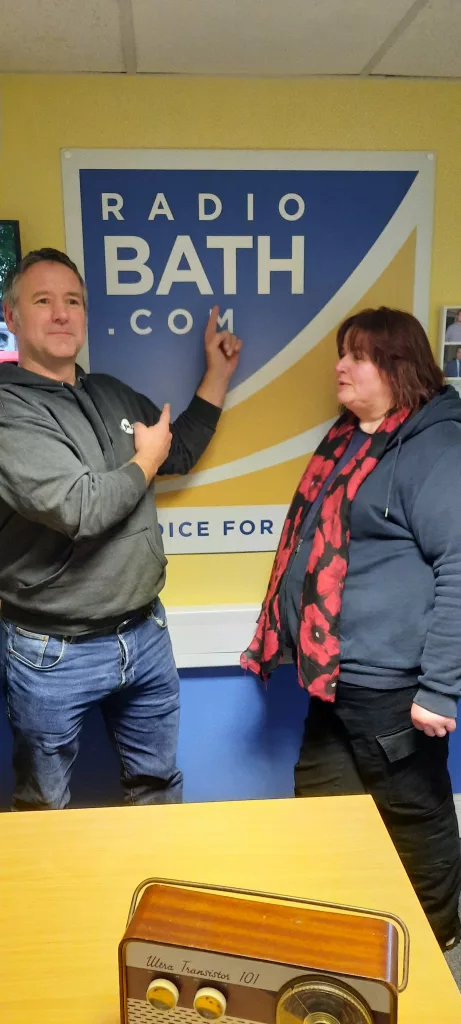 Rich and Ali posing next to the Radio Bath sign